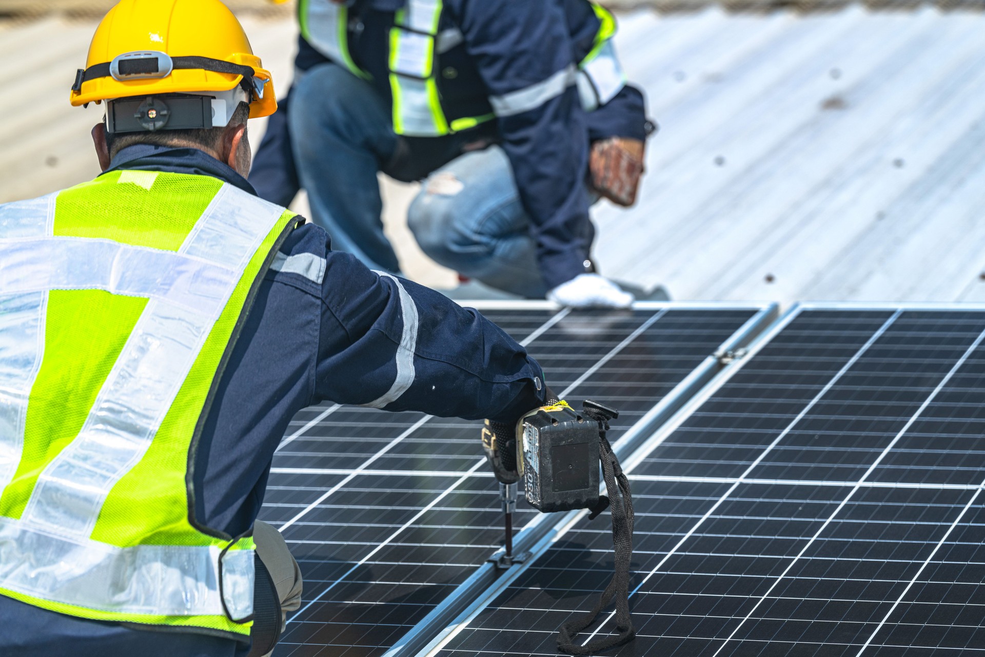 engineer men inspects construction of solar cell panel or photovoltaic cell at roof top. Industrial Renewable energy of green power. factory at urban area. worker working on tower roof.